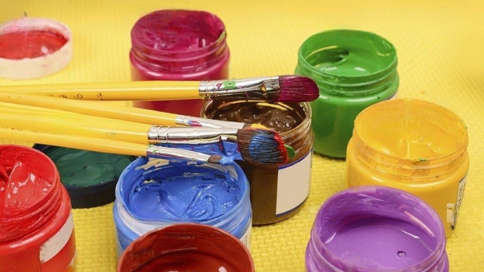 Acrylic Paints And Paintbrushes For Painting A Pickleball Paddle